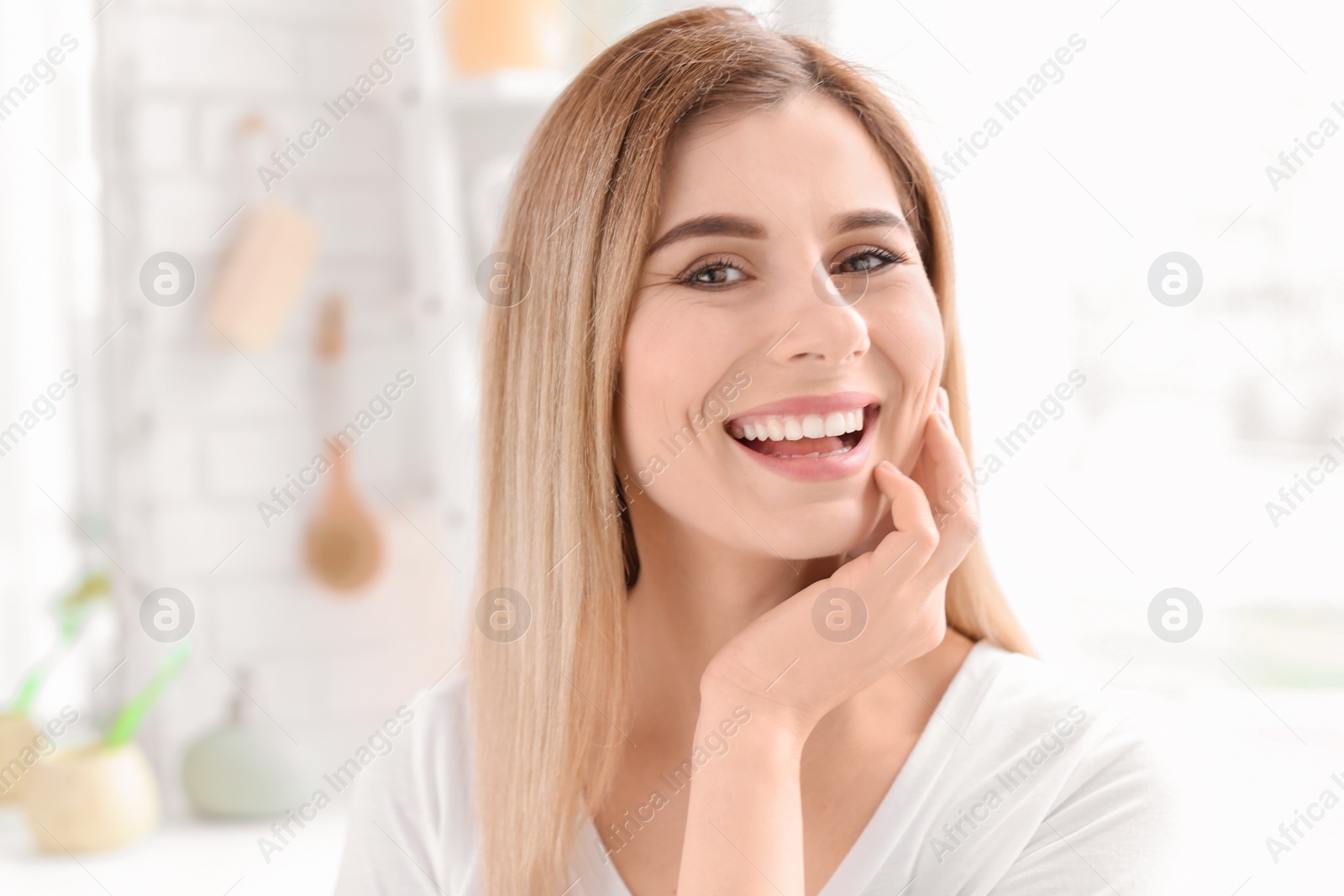 Photo of Young woman with beautiful smile indoors. Teeth whitening