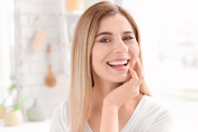 Young woman with beautiful smile indoors. Teeth whitening