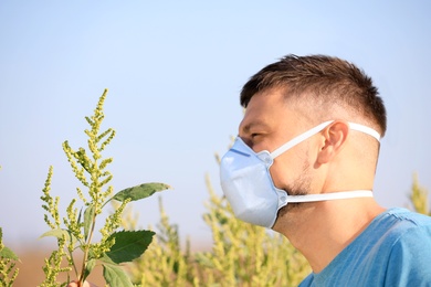 Photo of Man suffering from ragweed allergy outdoors on sunny day