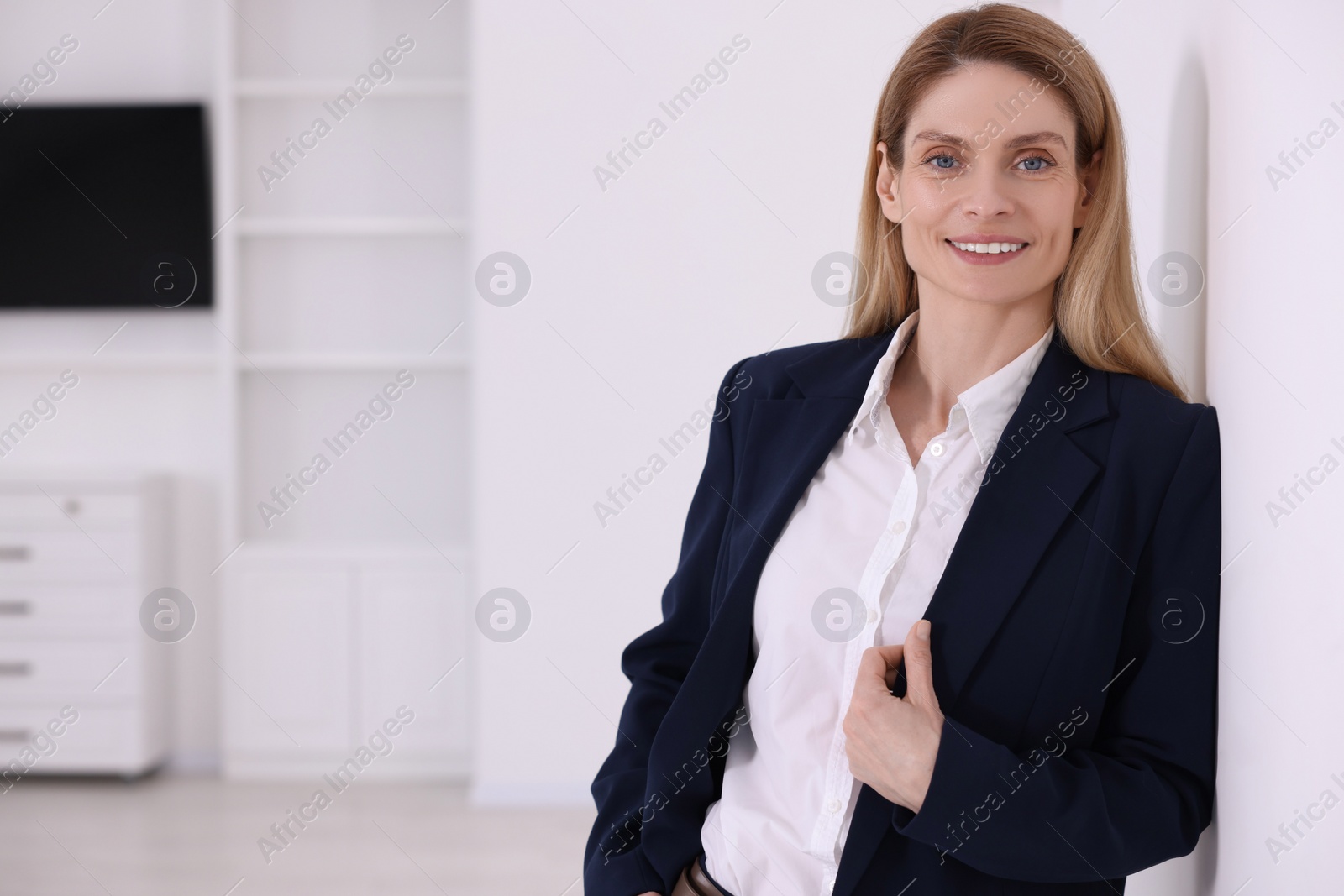 Photo of Happy real estate agent in new apartment. Space for text