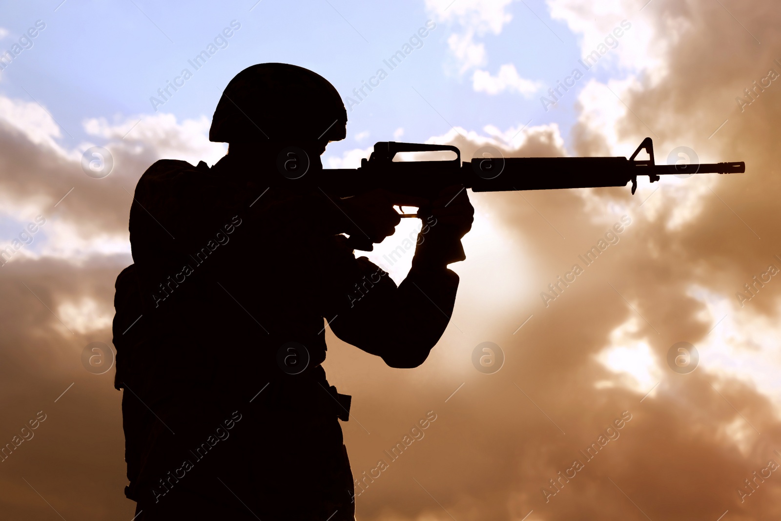 Photo of Soldier with machine gun patrolling outdoors. Military service