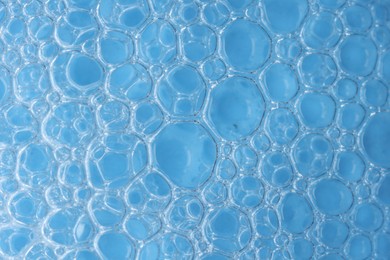 Photo of Macro photo of bubbles on light blue background, top view