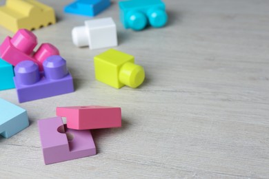 Photo of Colorful wooden blocks on white table, space for text. ABA therapy concept