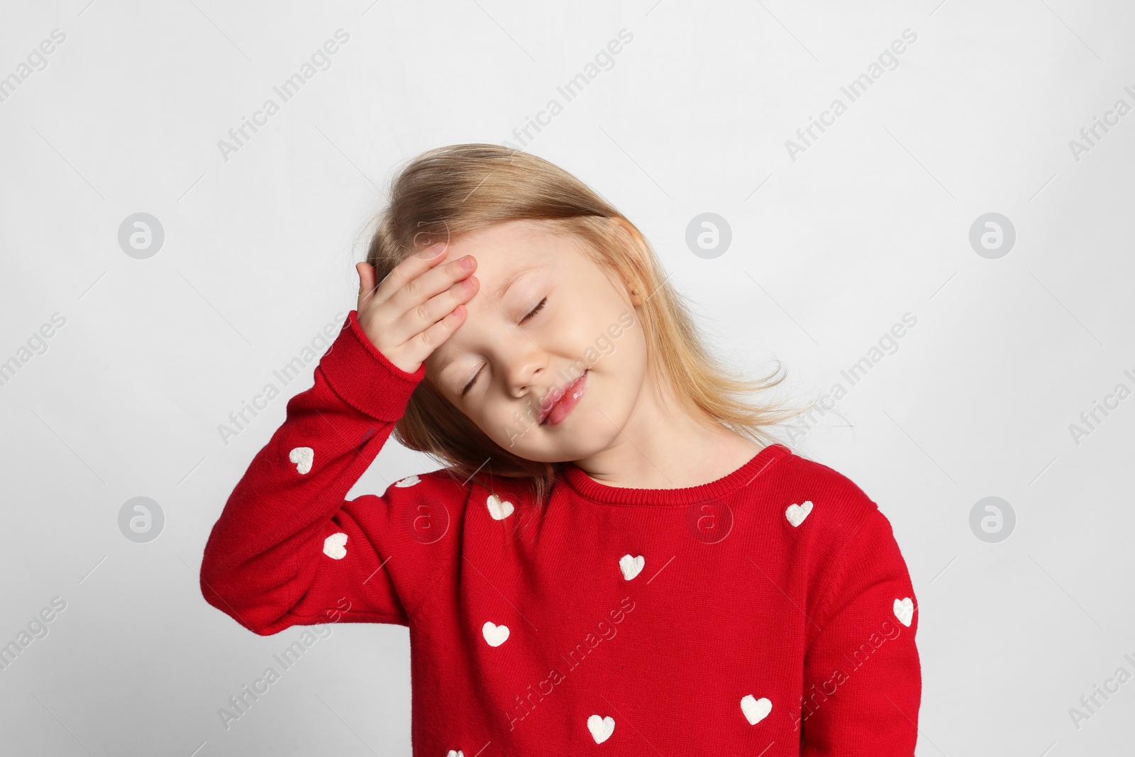 Photo of Portrait of cute little girl on light grey background