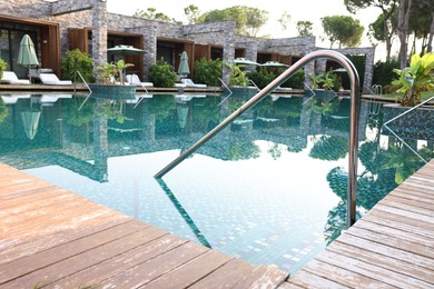 Photo of Outdoor swimming pool with wooden deck at resort