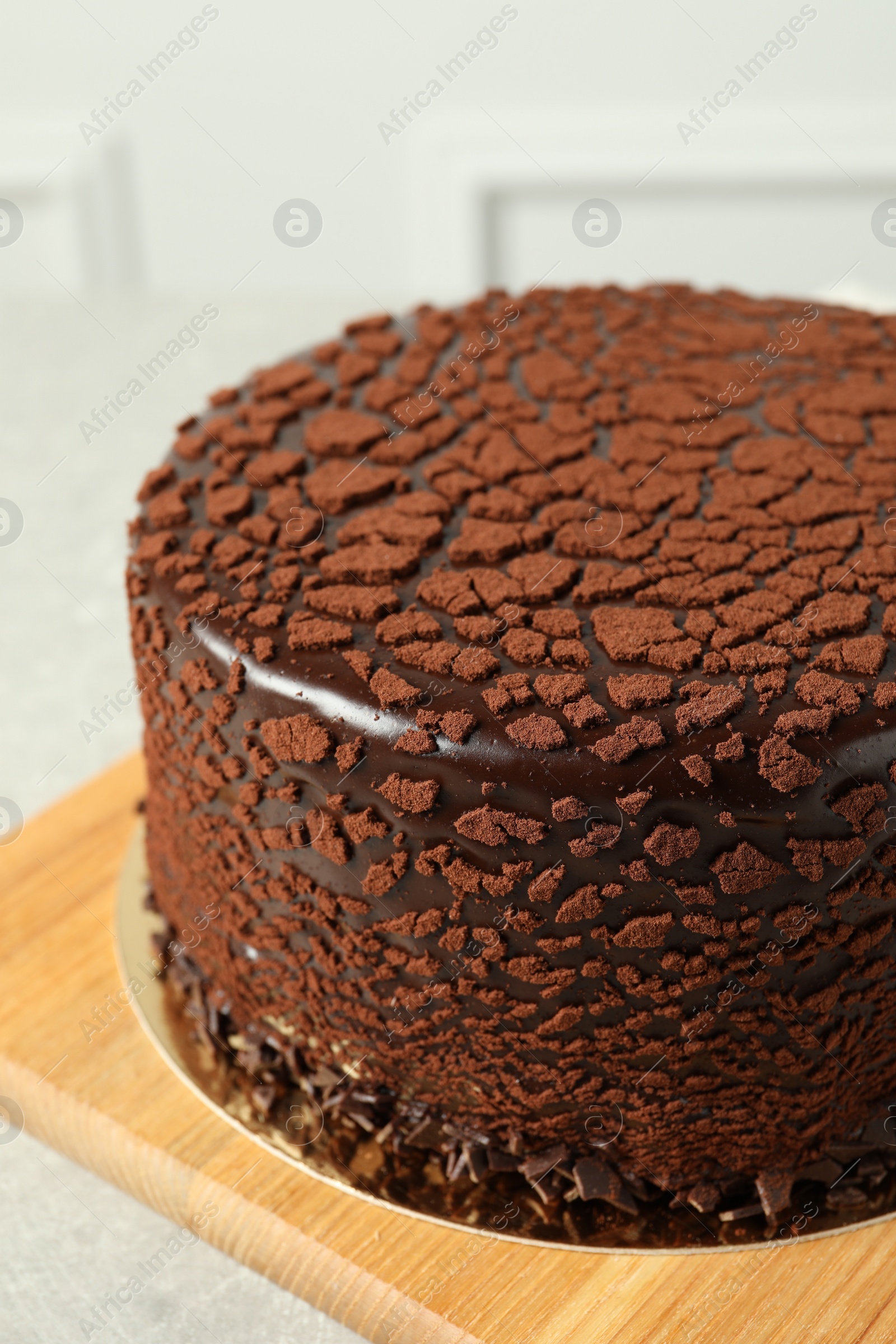 Photo of Delicious chocolate truffle cake on light grey table, closeup
