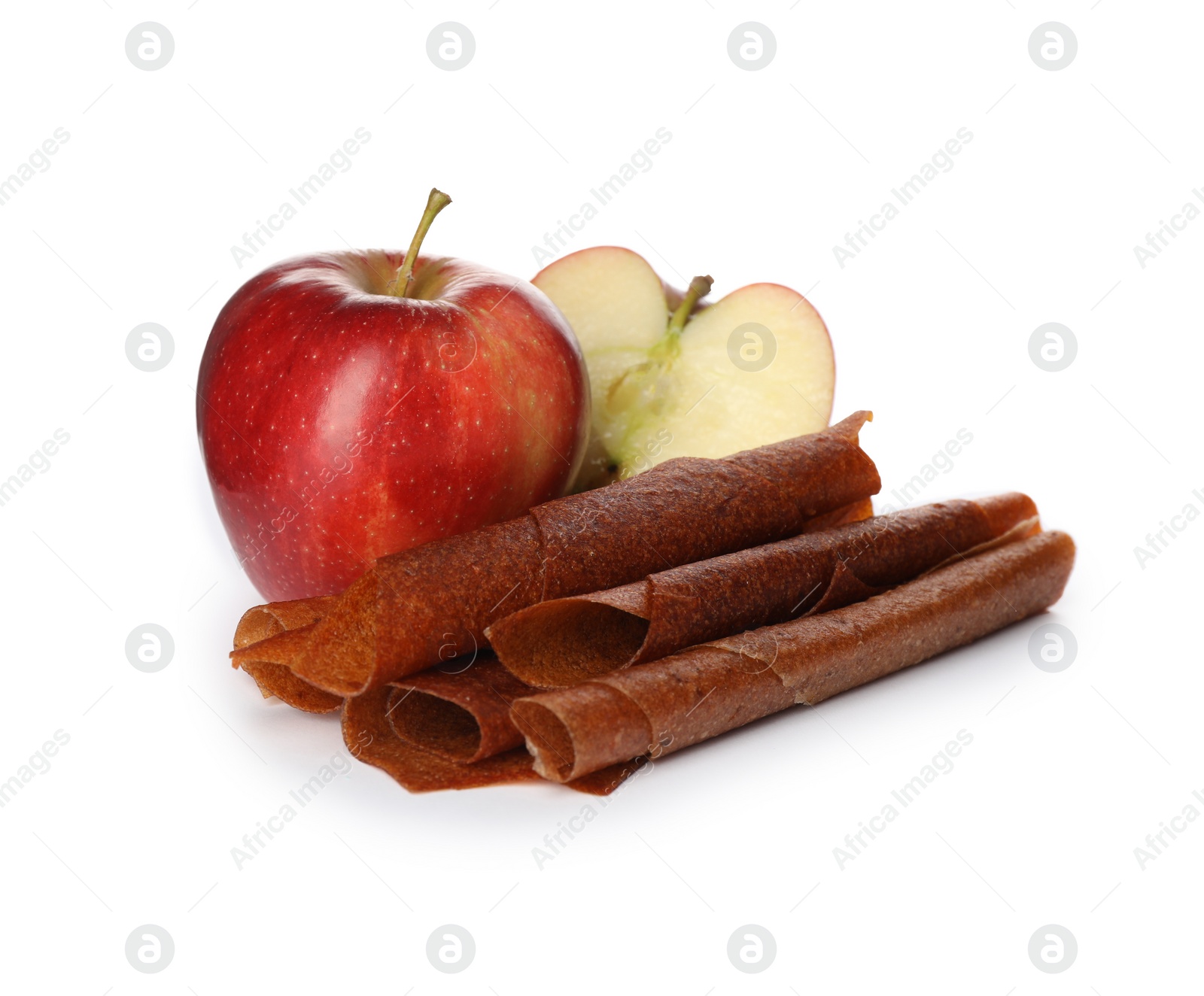 Photo of Delicious fruit leather rolls and apples on white background