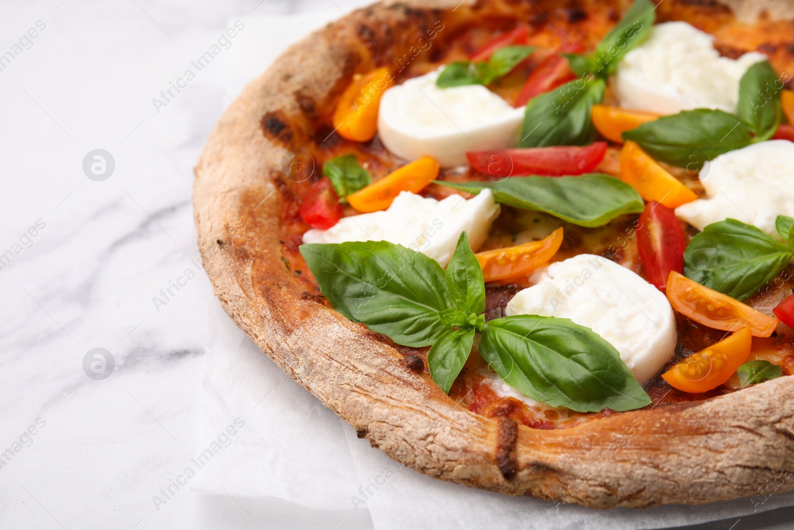 Photo of Delicious pizza with burrata cheese, tomatoes and basil on white marble table, closeup. Space for text