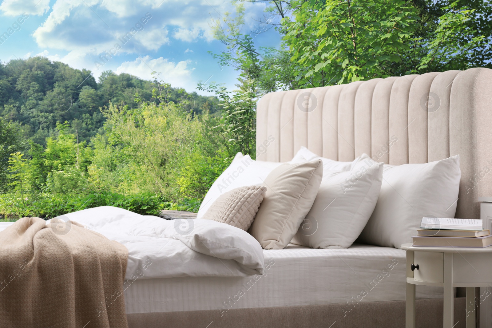 Image of Comfortable bed with soft pillows and picturesque view of mountains on background