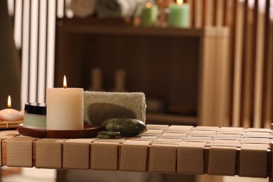 Photo of Beautiful composition with different spa products on wicker bench indoors, space for text