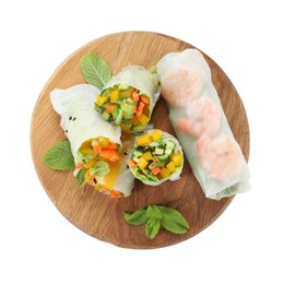 Board with tasty spring rolls isolated on white, top view