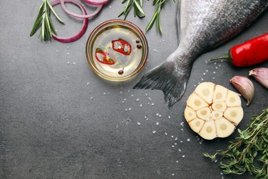 Fresh dorado fish and ingredients on grey table, flat lay. Space for text