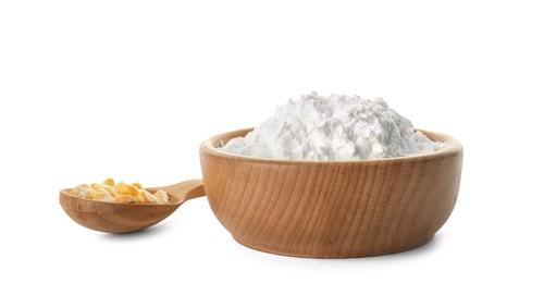 Bowl of corn starch and spoon with kernels on white background