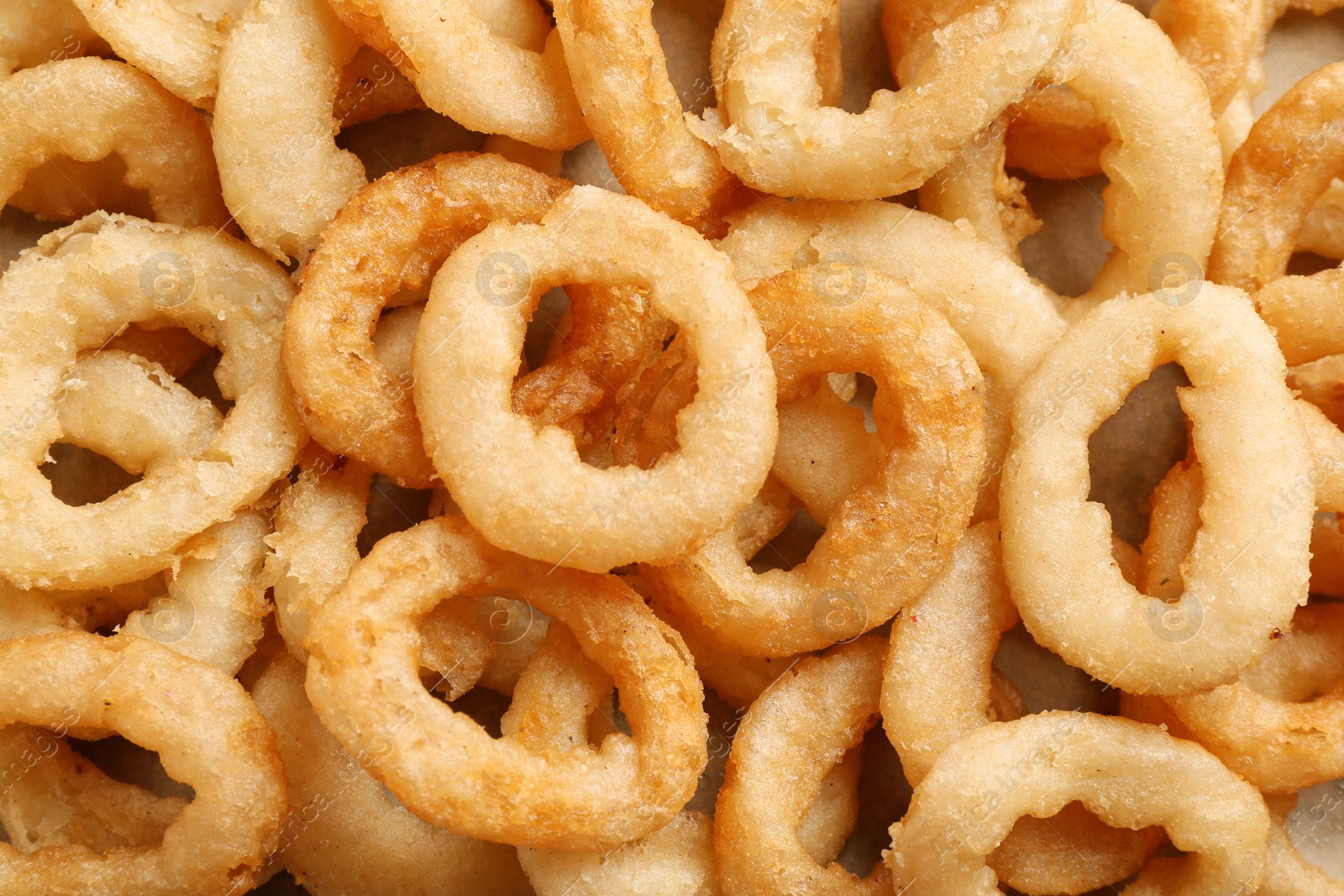 Photo of Freshly cooked onion rings as background