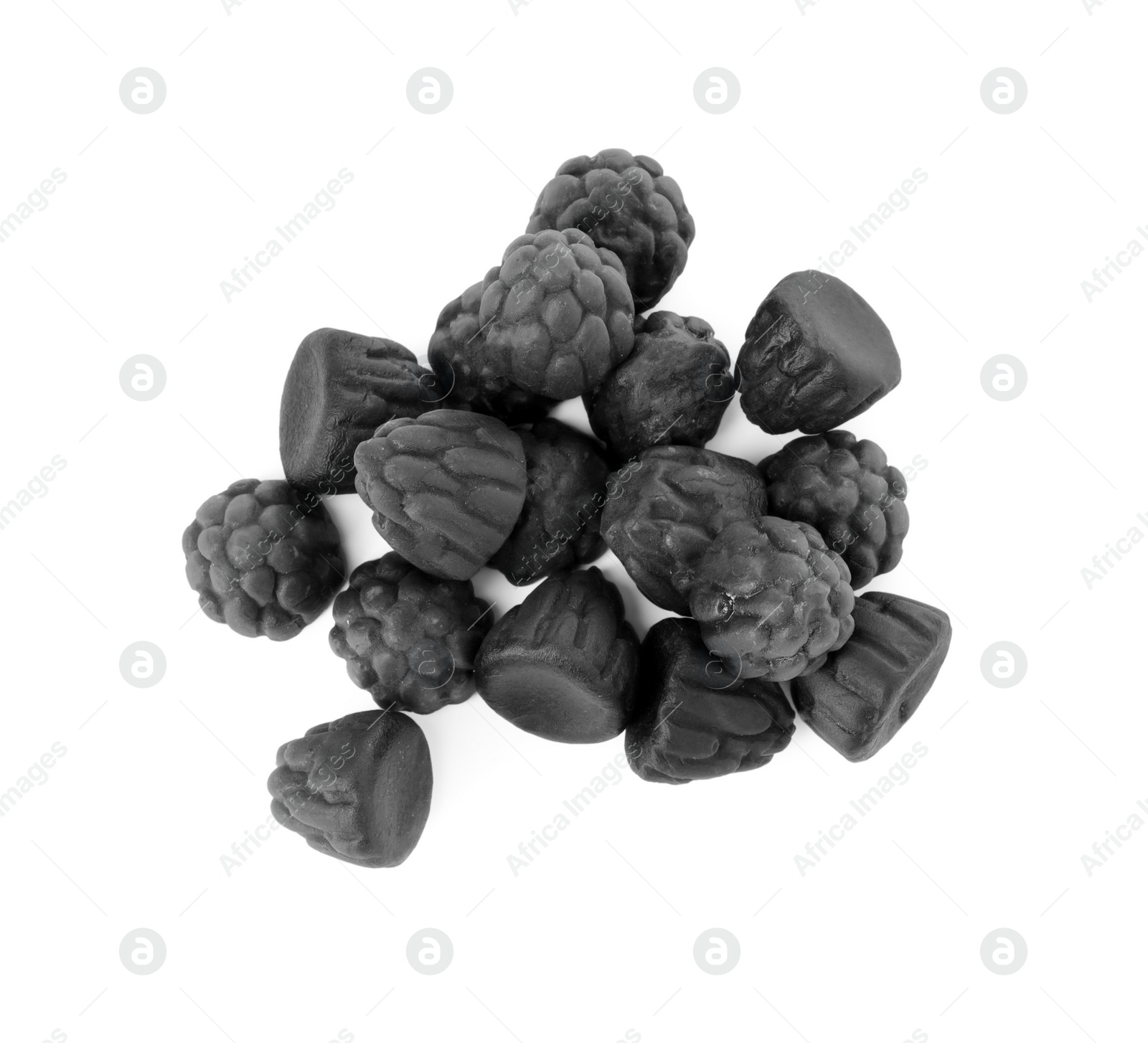 Photo of Delicious chewy candies with liquorice isolated on white, top view