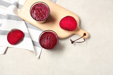 Flat lay composition with beet smoothies on light background. Space for text