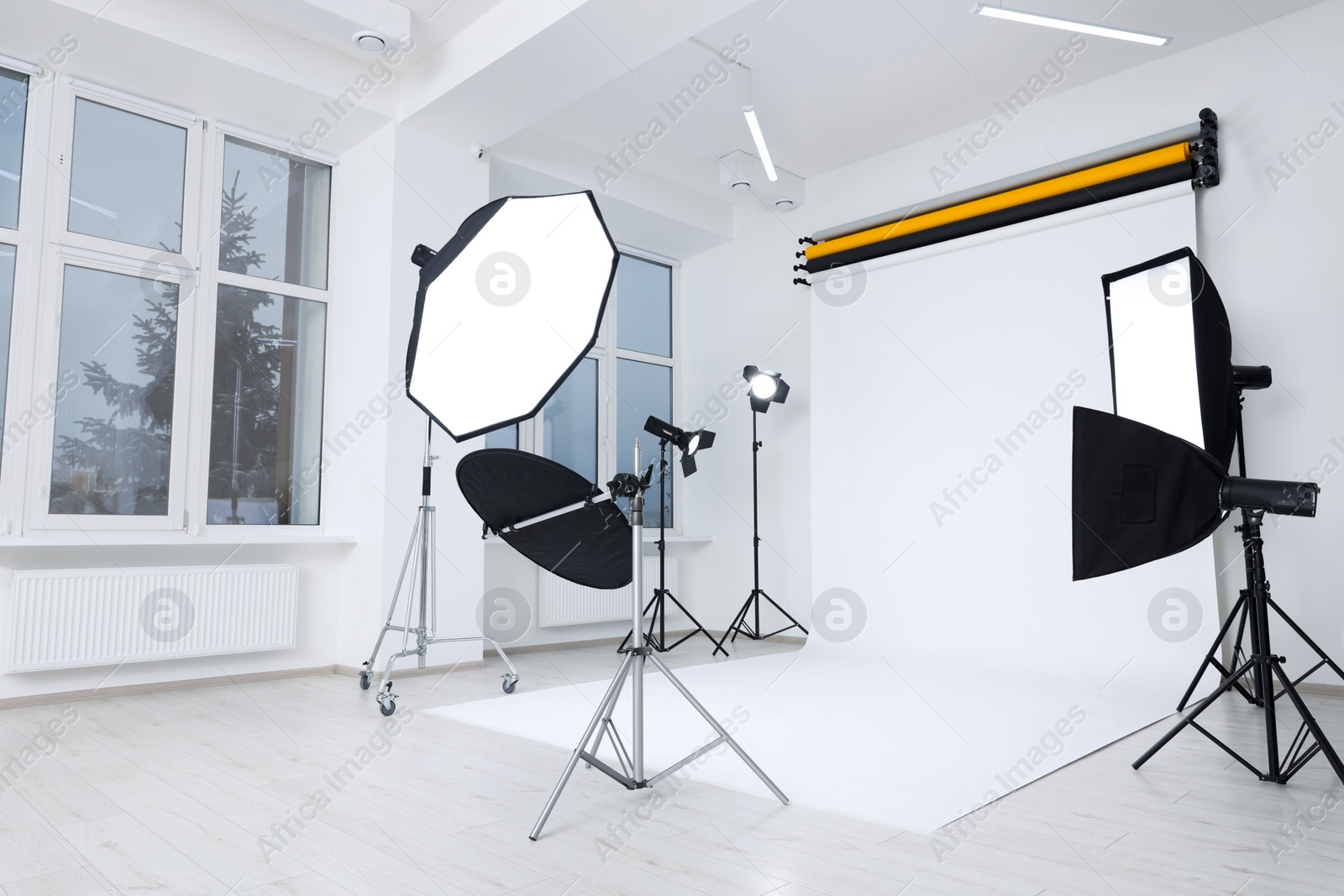 Photo of Interior of modern photo studio with professional lighting equipment