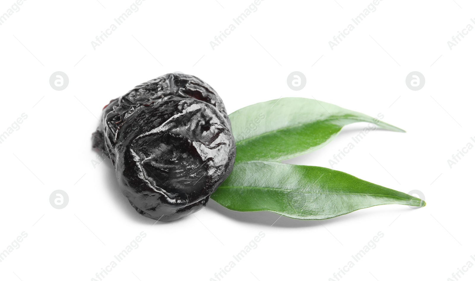 Photo of Tasty prunes and leaves on white background. Dried fruit as healthy snack