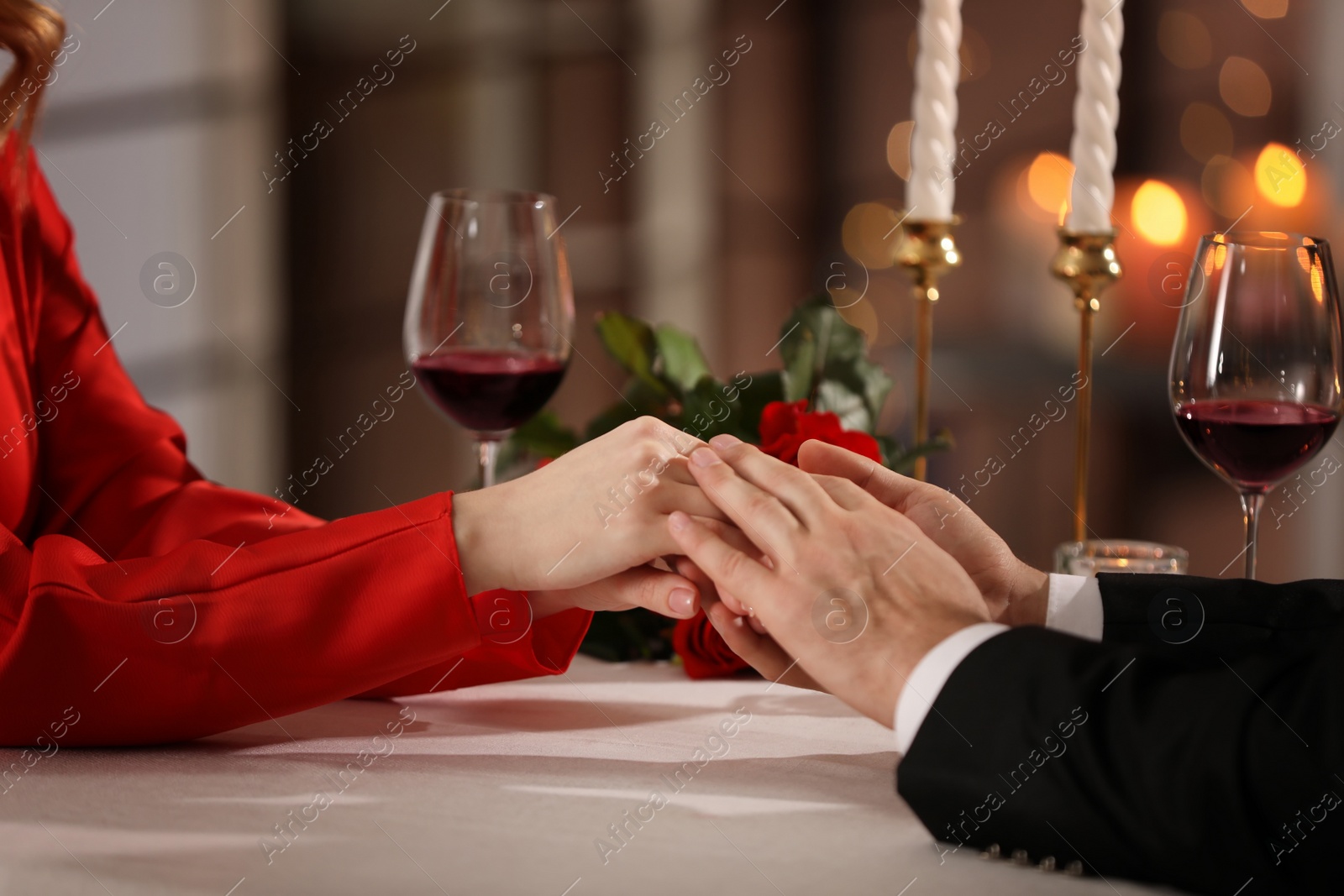 Photo of Couple having romantic dinner on Valentine's day in restaurant, closeup