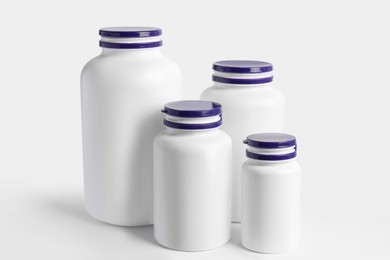 Photo of Different plastic medicine bottles on white background. Medicament