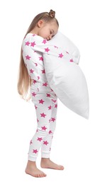 Girl in pajamas hugging pillow on white background