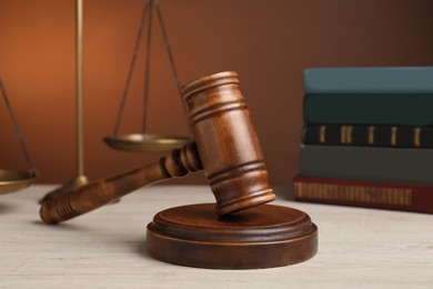 Photo of Wooden gavel on white table. Law concept