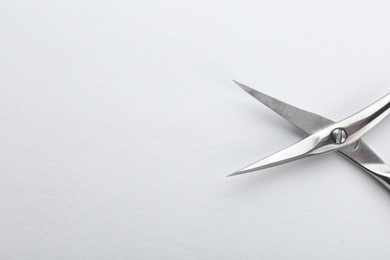 Photo of Pair of nail scissors on white background, closeup