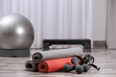 Set of fitness equipment on floor indoors. Space for text