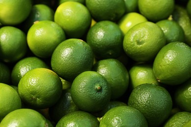 Fresh ripe green limes as background, closeup