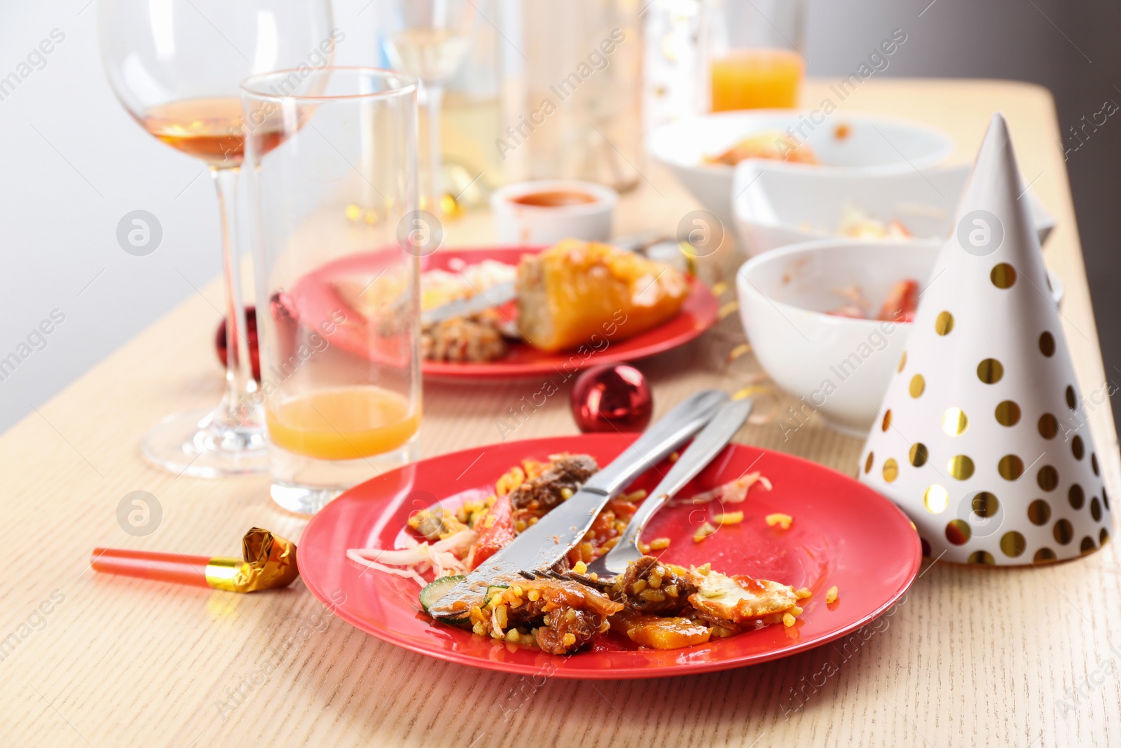 Photo of Food leftovers after party on wooden table