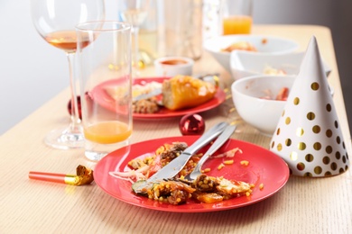 Photo of Food leftovers after party on wooden table