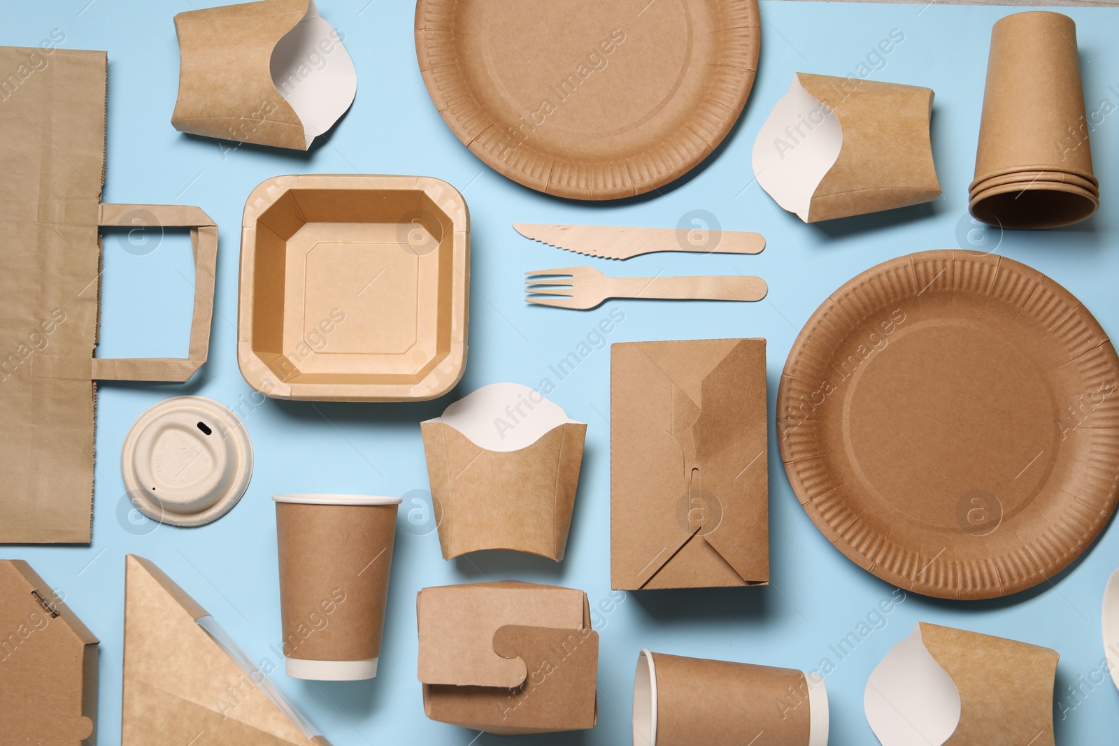 Photo of Flat lay composition with eco friendly food packagings on light blue background