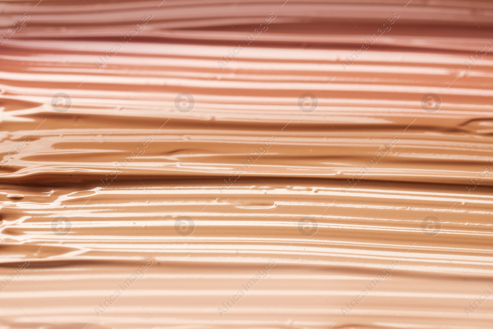 Image of Different shades of liquid foundation as background, closeup