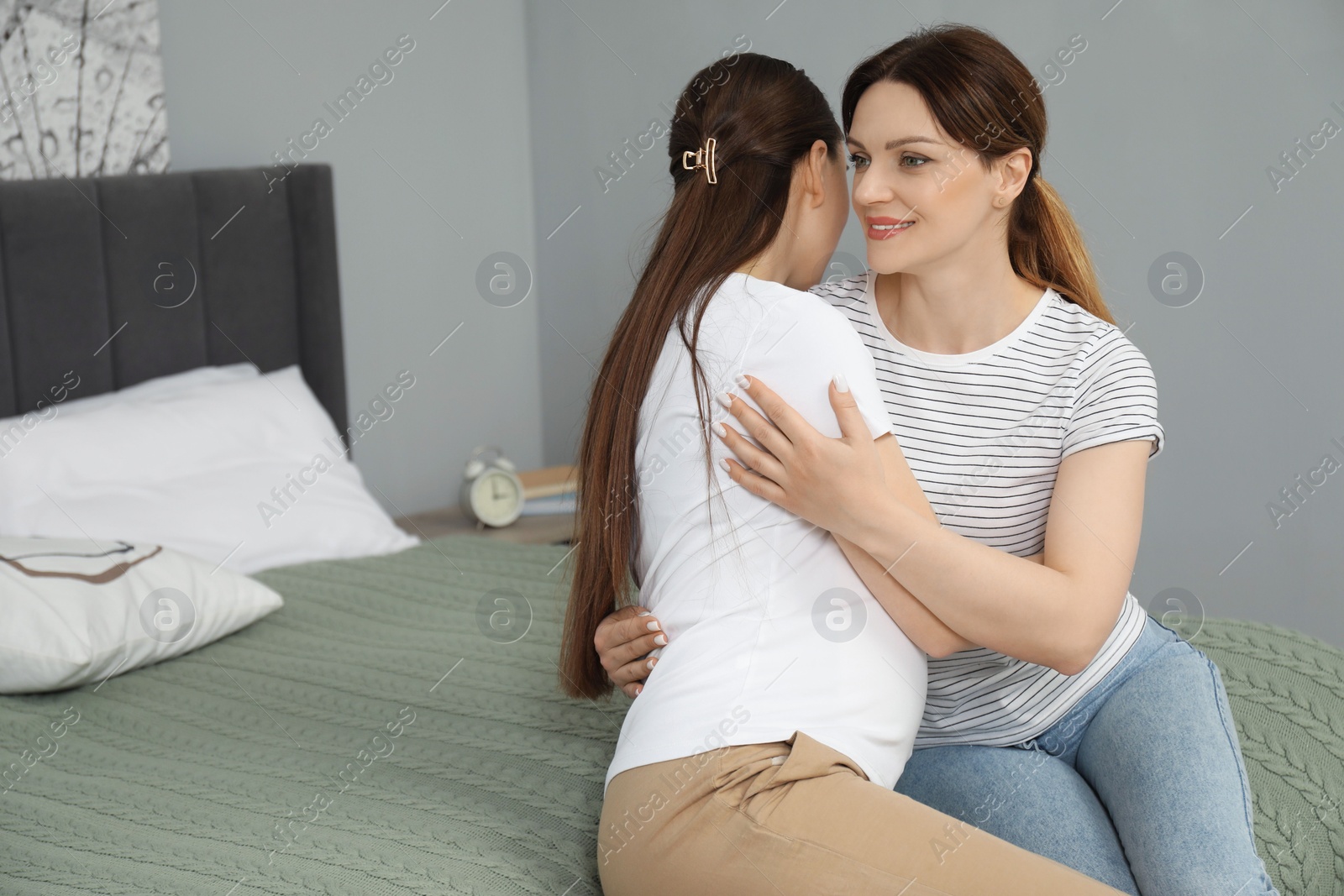 Photo of Doula hugging pregnant woman in bedroom. Preparation for child birth