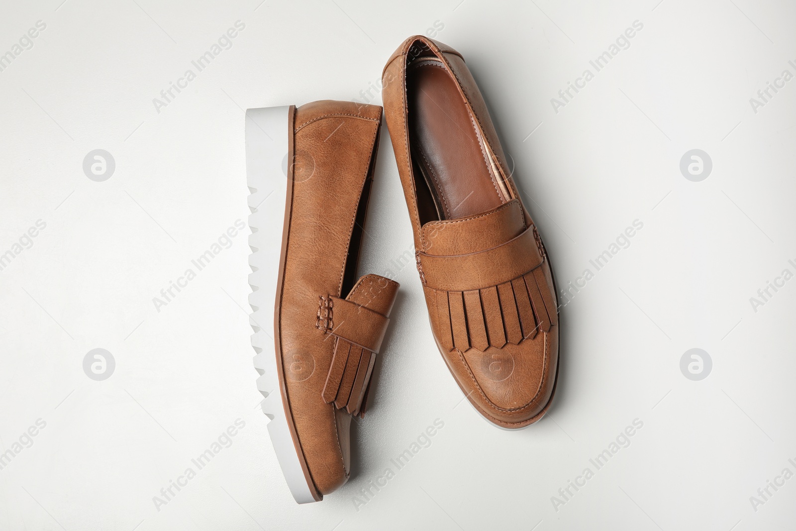 Photo of Pair of female shoes on white background