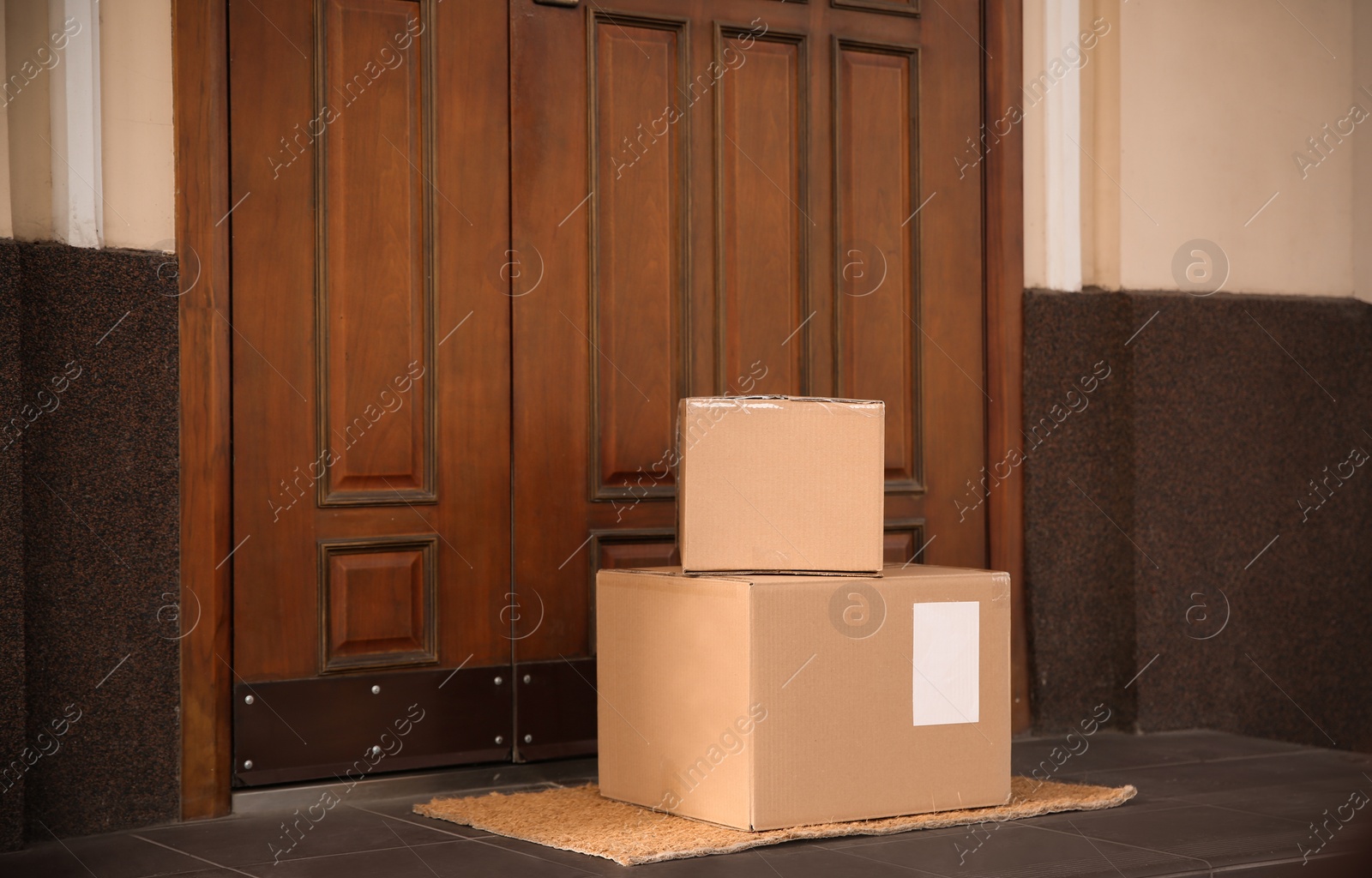 Photo of Delivered parcels on door mat near entrance