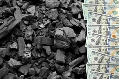 Image of Dollar banknotes on pieces of coal, top view. Resource price