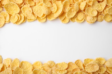 Breakfast cereal. Tasty corn flakes on white background, flat lay. Space for text