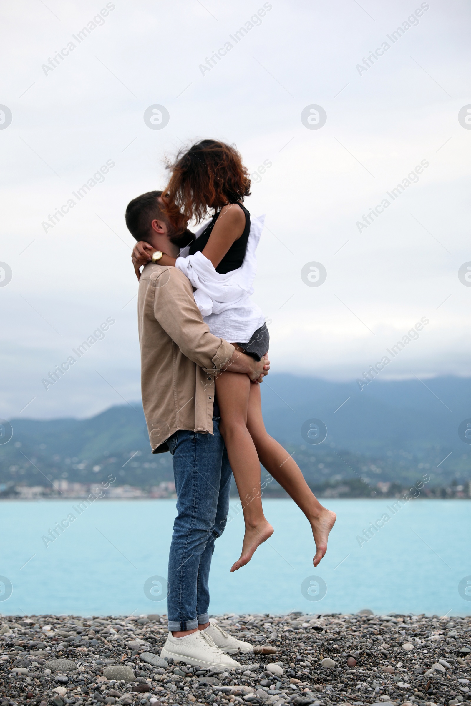 Photo of Beautiful young couple enjoying time together on beach