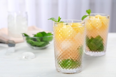 Photo of Tasty melon ball drink in glasses on table