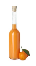 Photo of Bottle of tasty tangerine liqueur and fresh fruit isolated on white