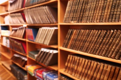 Blurred view of books on shelves in library