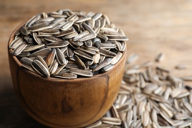 Photo of Raw sunflower seeds on table, closeup view
