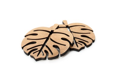 Leaf shaped wooden cup coasters on white background