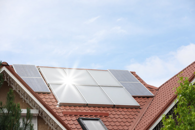 House with installed solar panels on roof