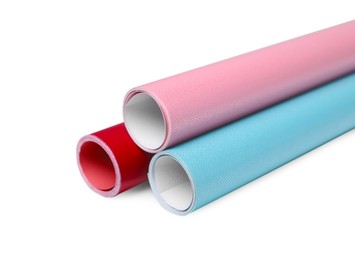 Photo of Rolls of colorful wrapping papers on white background, closeup