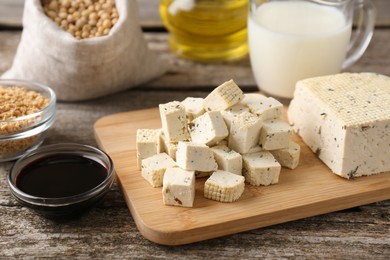 Photo of Different natural soy products on wooden table, closeup