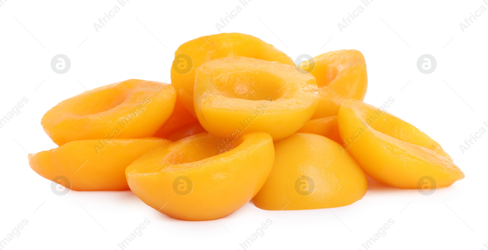 Photo of Halves of canned peaches isolated on white