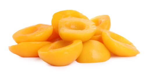 Photo of Halves of canned peaches isolated on white