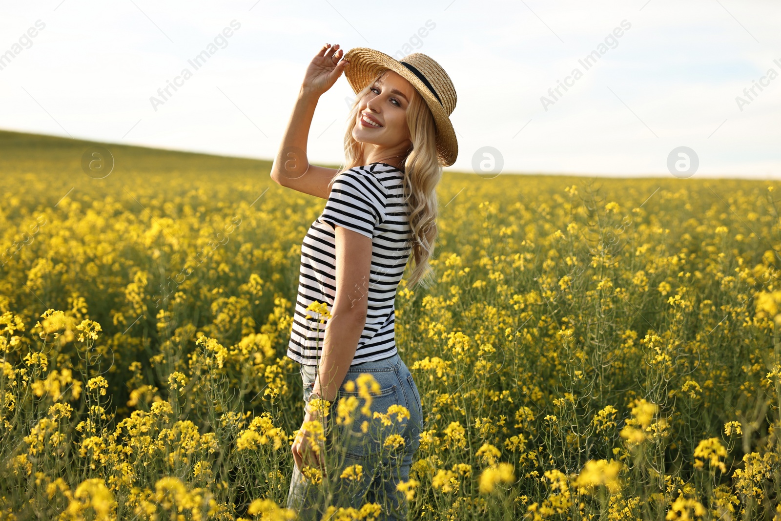 Photo of Happy young woman with straw hat in field on spring day